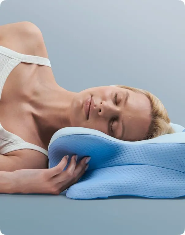 Woman sleeping on her side on a contoured pillow